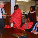 Head teacher Mike Mollel of Olchoki Primary School presents a Maasai talking stick to U.S. Representative Jim McDermott